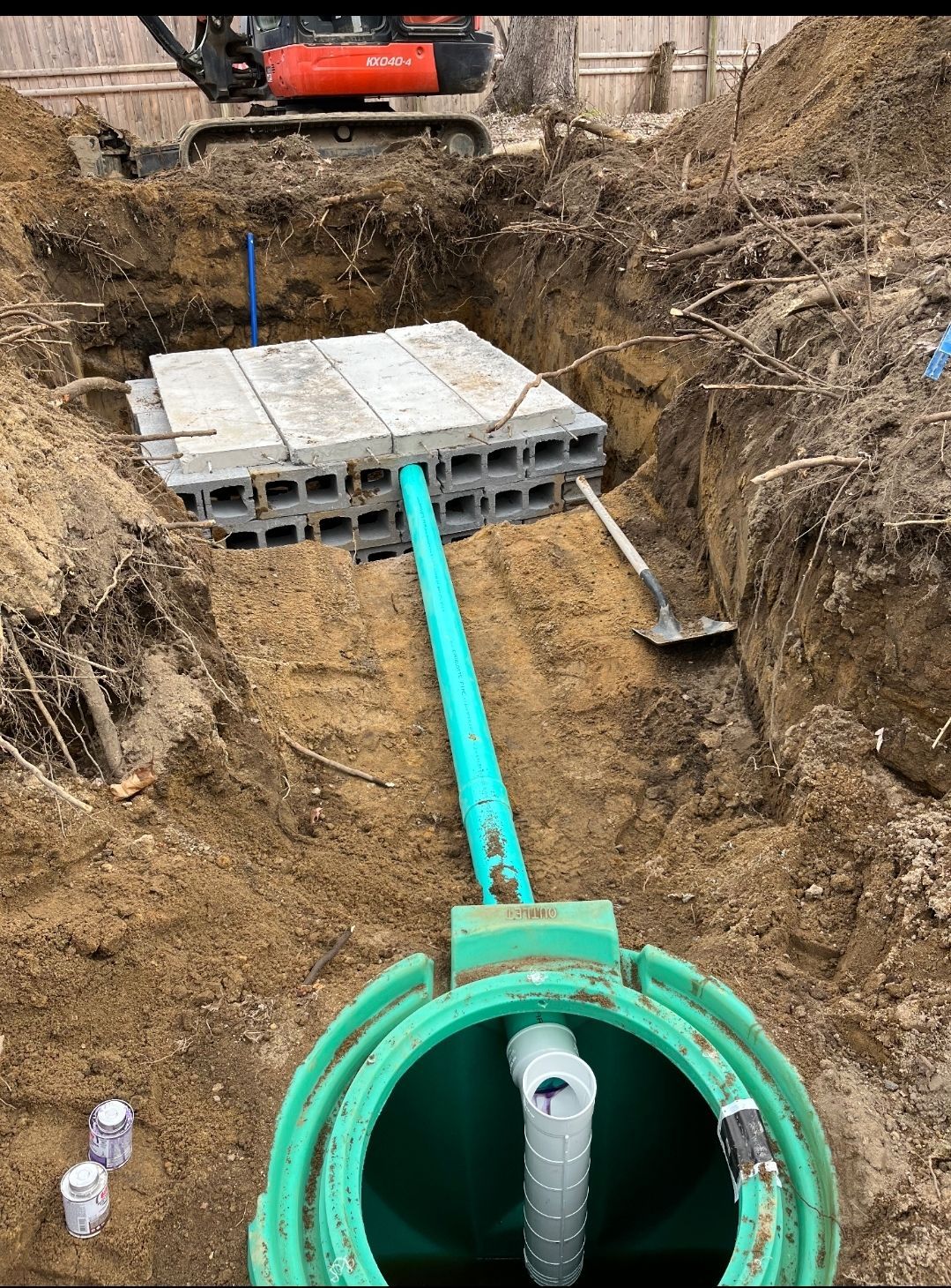 A pipe is being installed in a hole in the ground.