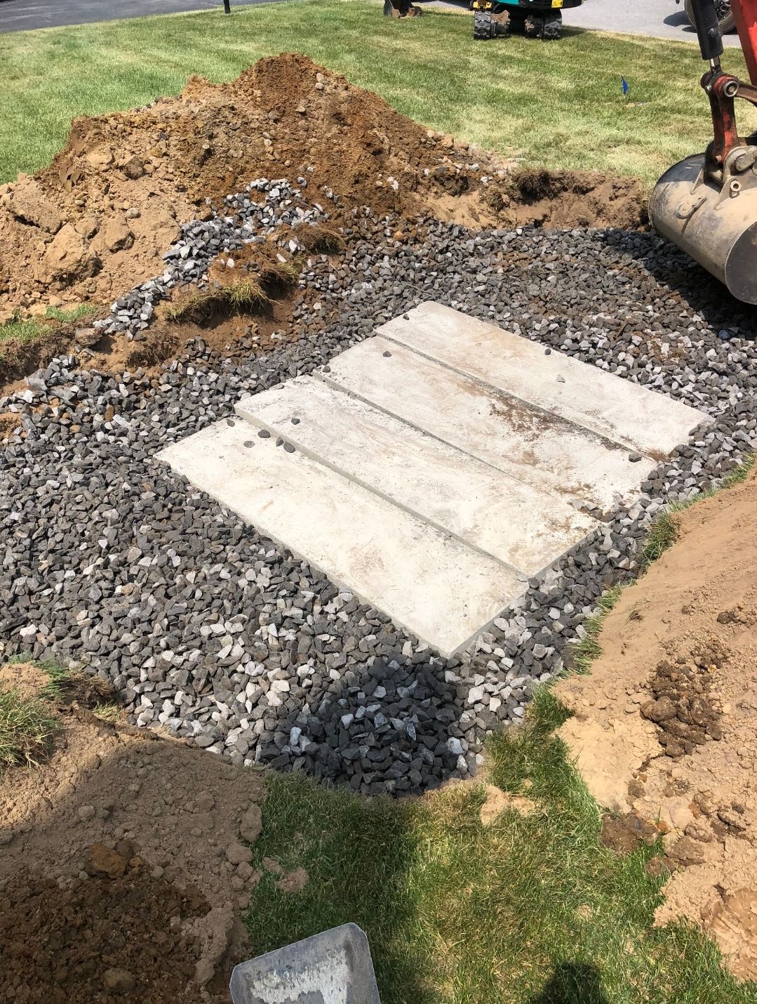 A concrete slab is sitting on top of a pile of gravel.