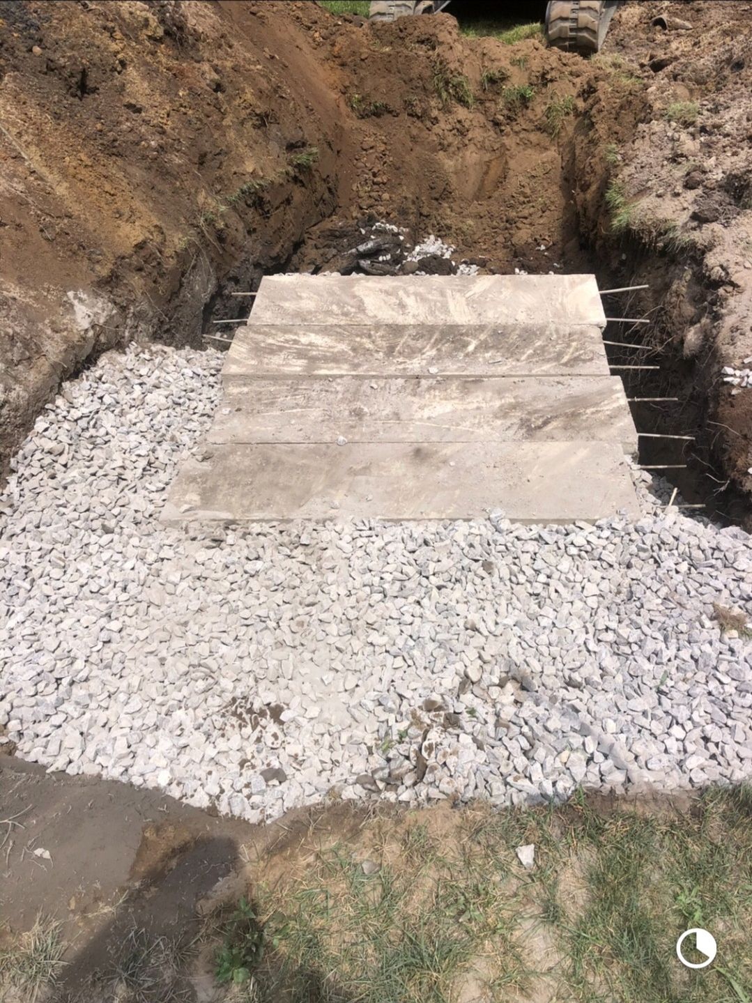 A concrete slab is sitting on top of a pile of gravel.