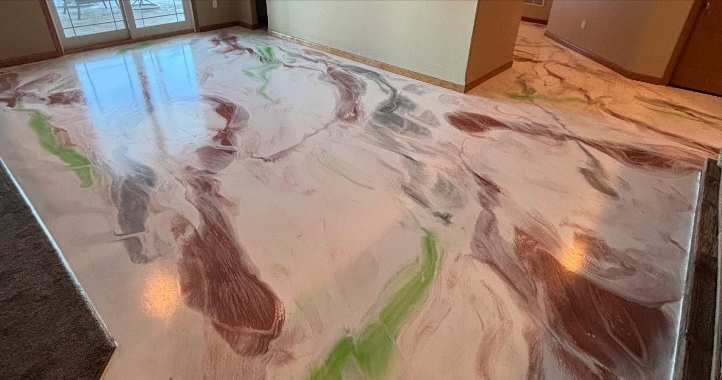 Marble epoxy floor with swirling white, brown, and green patterns in a room