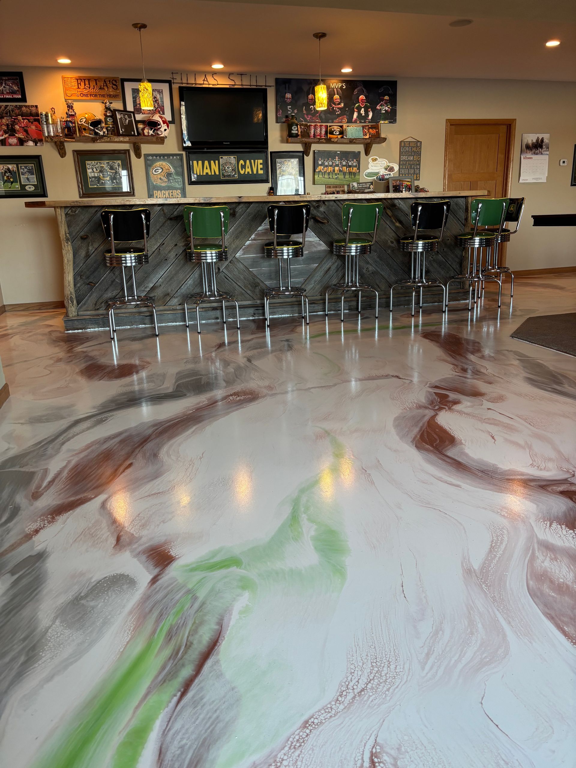 Bar with green stools and wall art, reflecting on a glossy marbled floor.