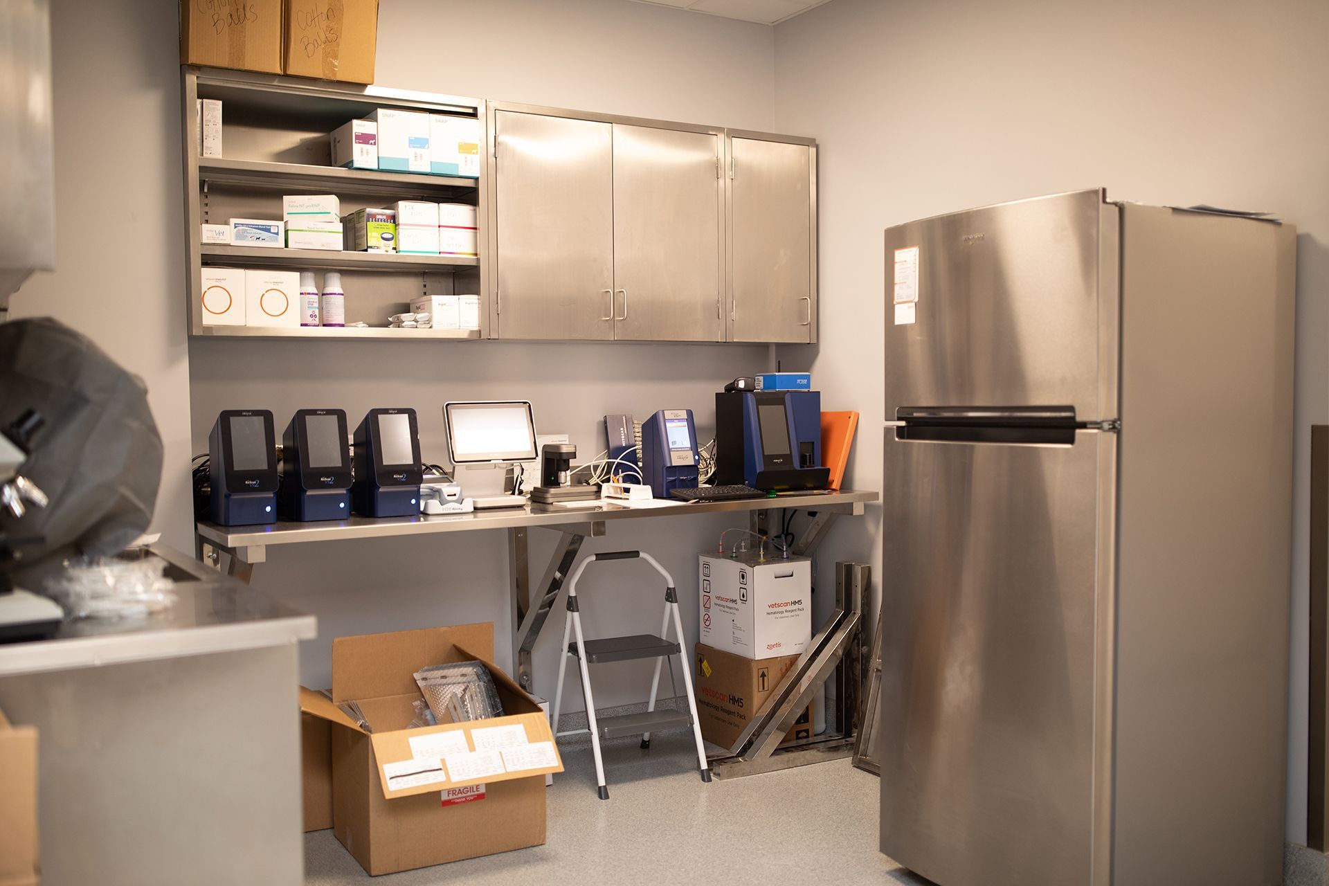 A kitchen with stainless steel cabinets and a refrigerator.