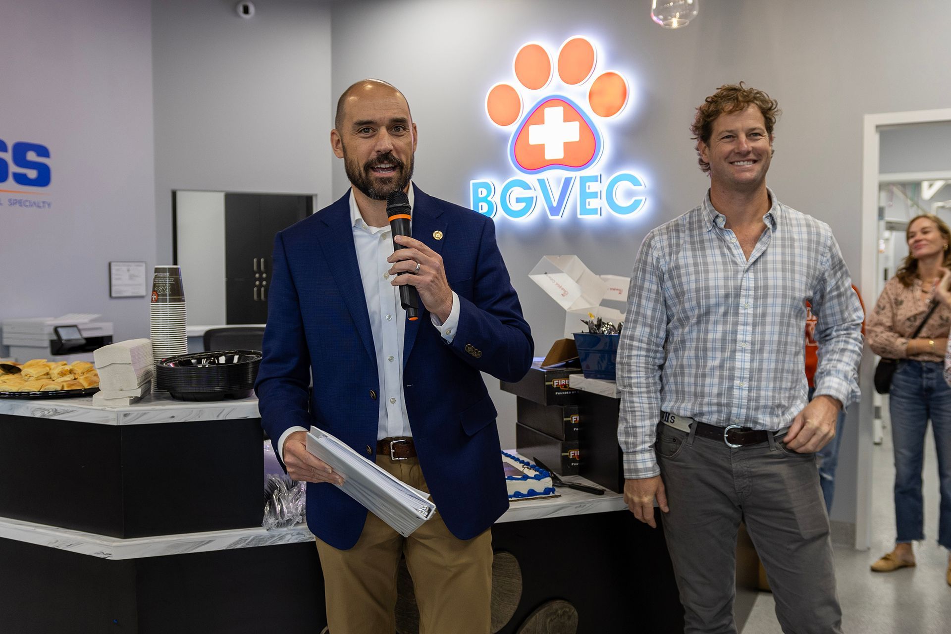 Two men are standing in the lobby of Bowling Green Veterinary Emergency Clinic