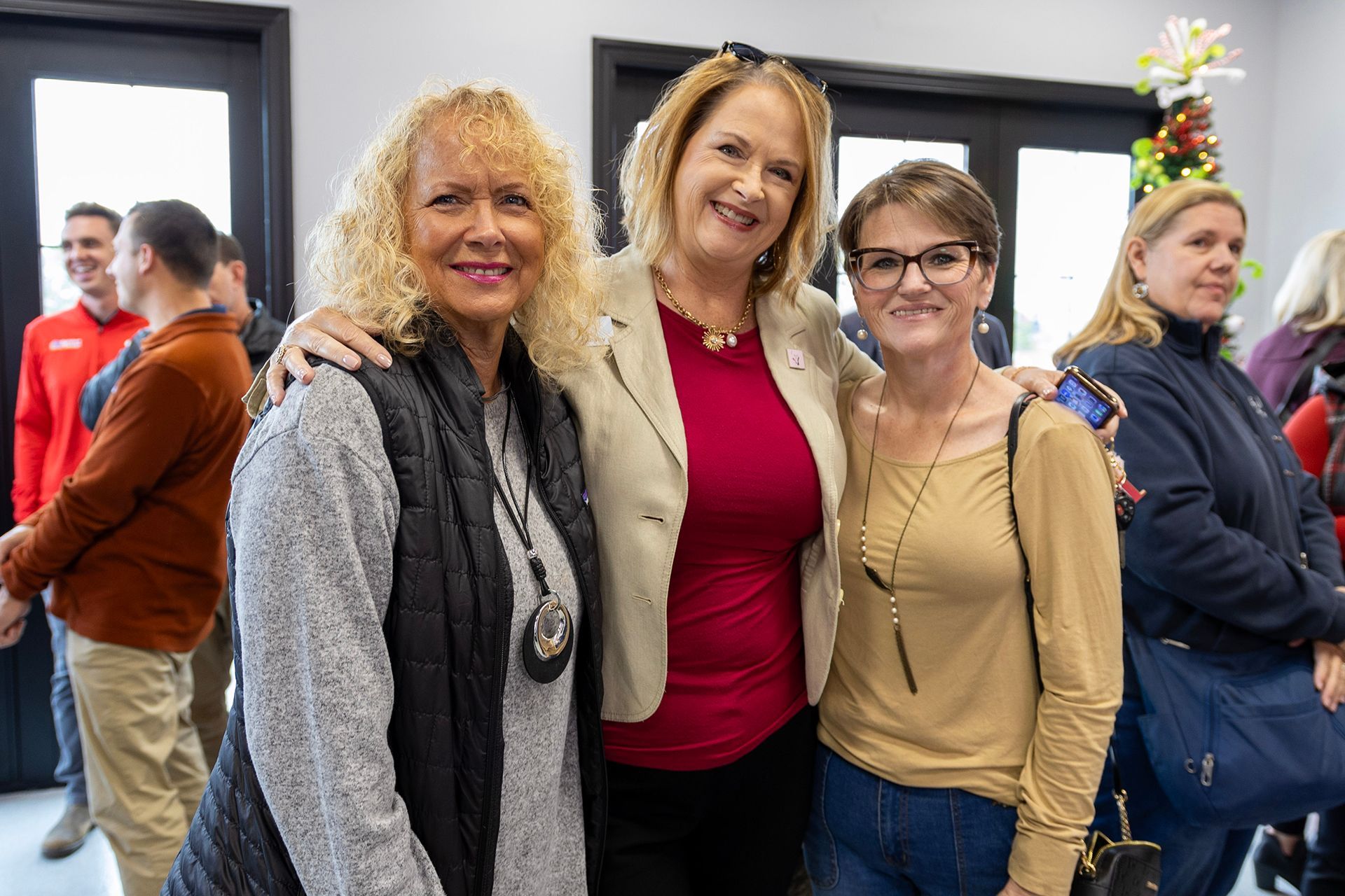 Three women at Bowling Green Veterinary Emergency Clinic are posing for a picture together in a room.