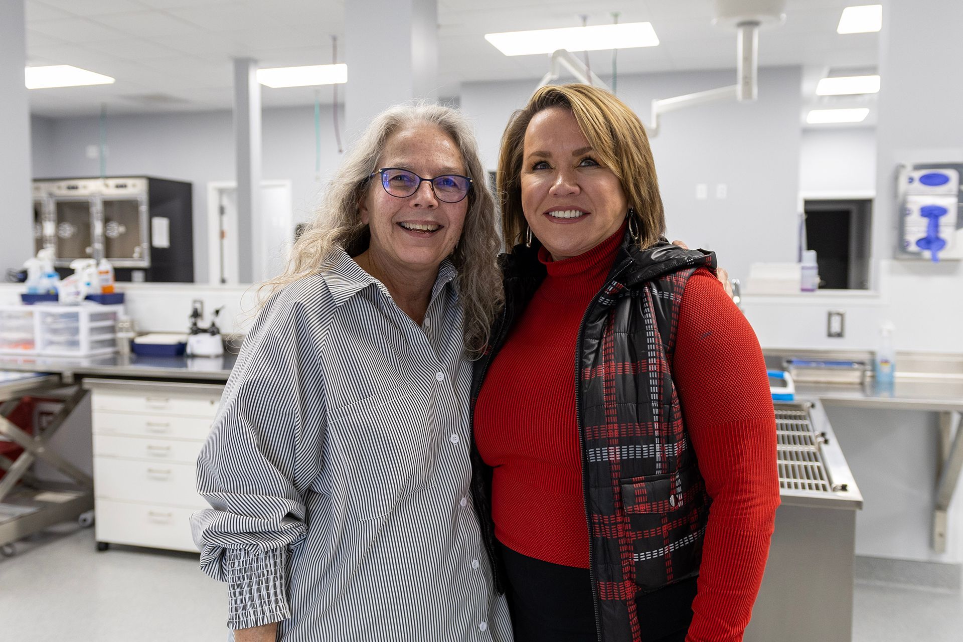 Two women are posing for a picture at Bowling Green Veterinary Emergency Clinic.