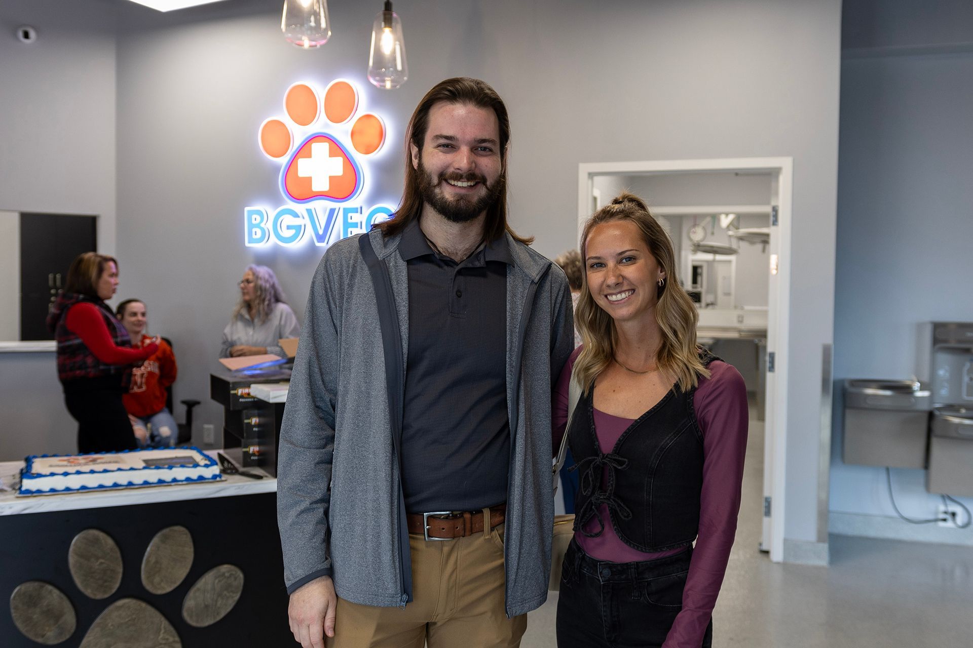 A man and a woman are standing next to each other in a room.