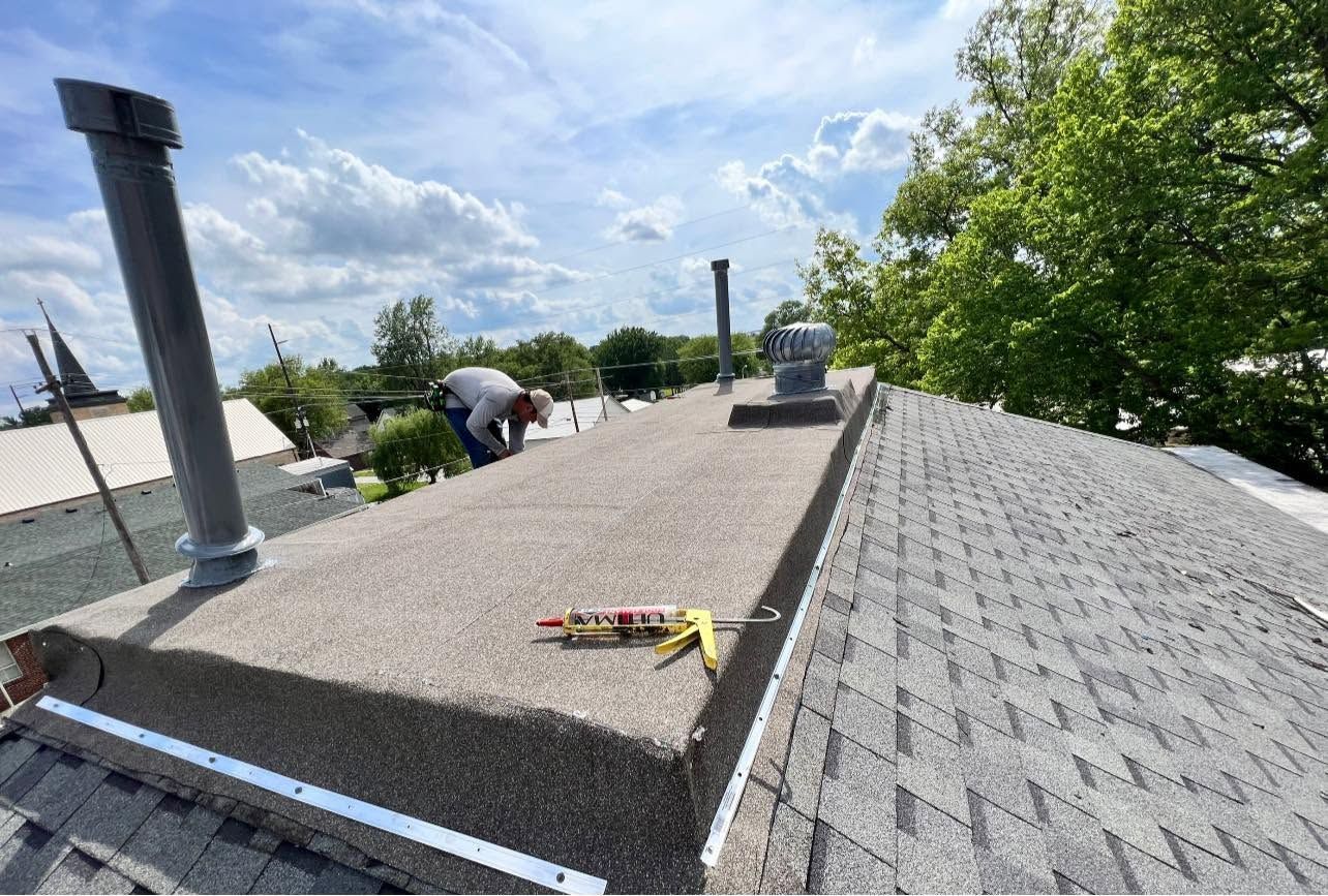 Roofing workers inspecting a flat roof with tools on a sunny day