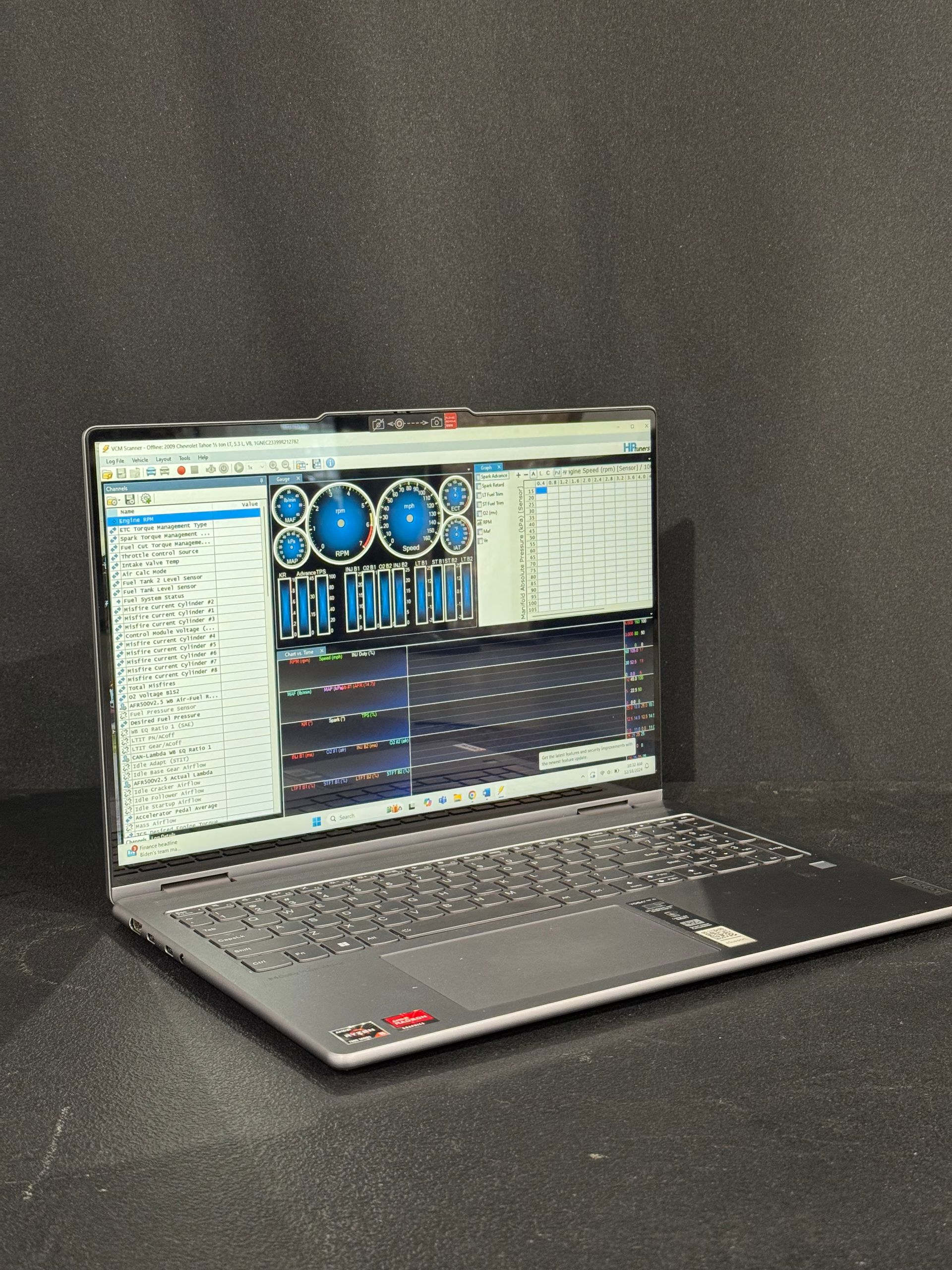 Laptop displaying software interface with blue and white elements, against a dark background.