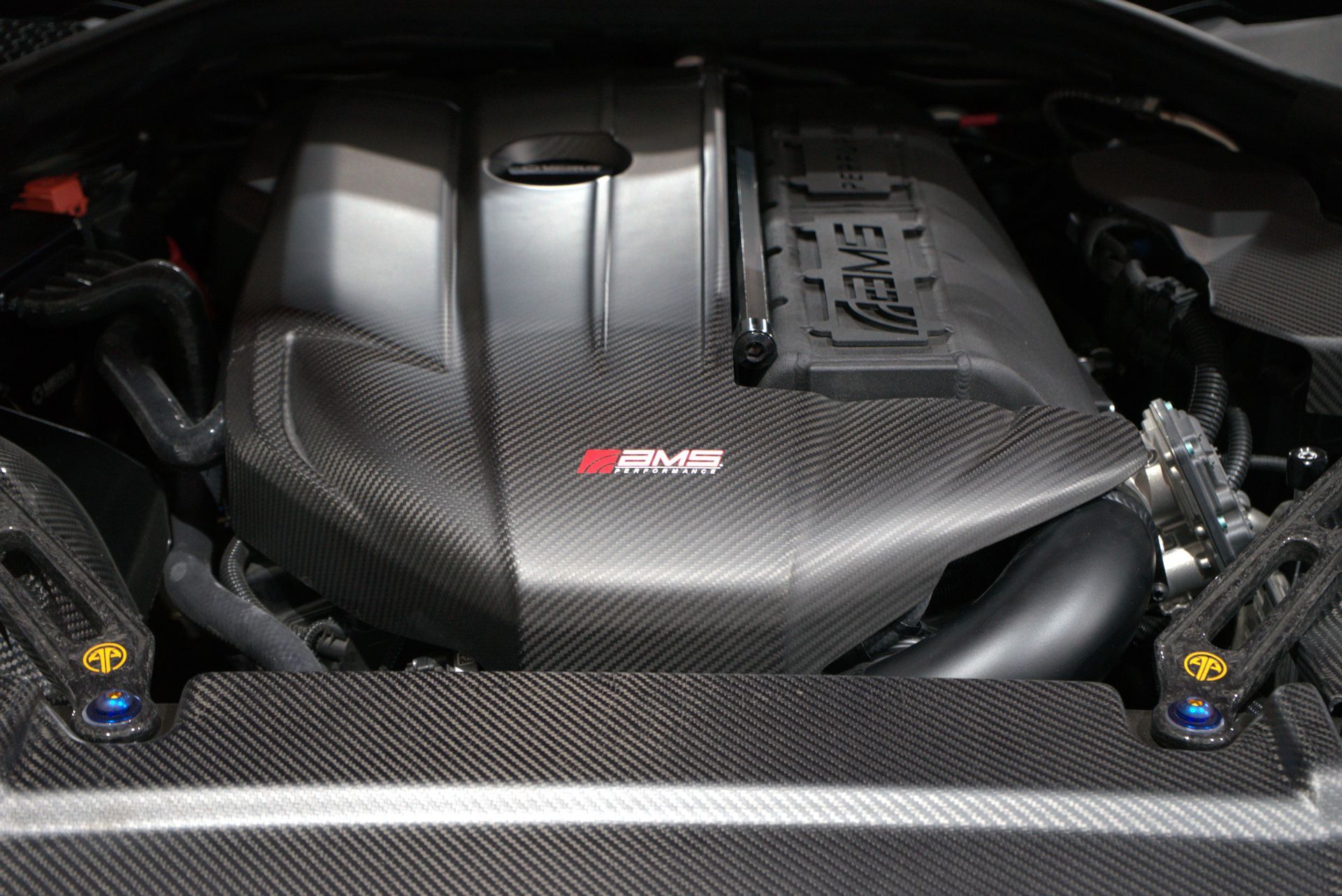 Carbon fiber car engine bay with black cover and red 