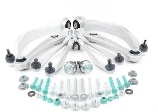 Car suspension kit with multiple silver control arms, bolts, and bushings.