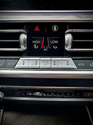 Car dashboard with climate control display: temperature controls, hazard lights, and USB ports.