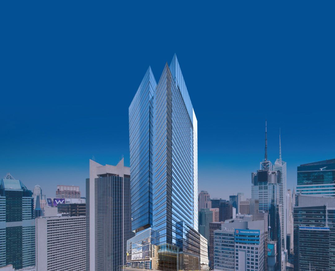 A large building in the middle of a city with a blue sky in the background.