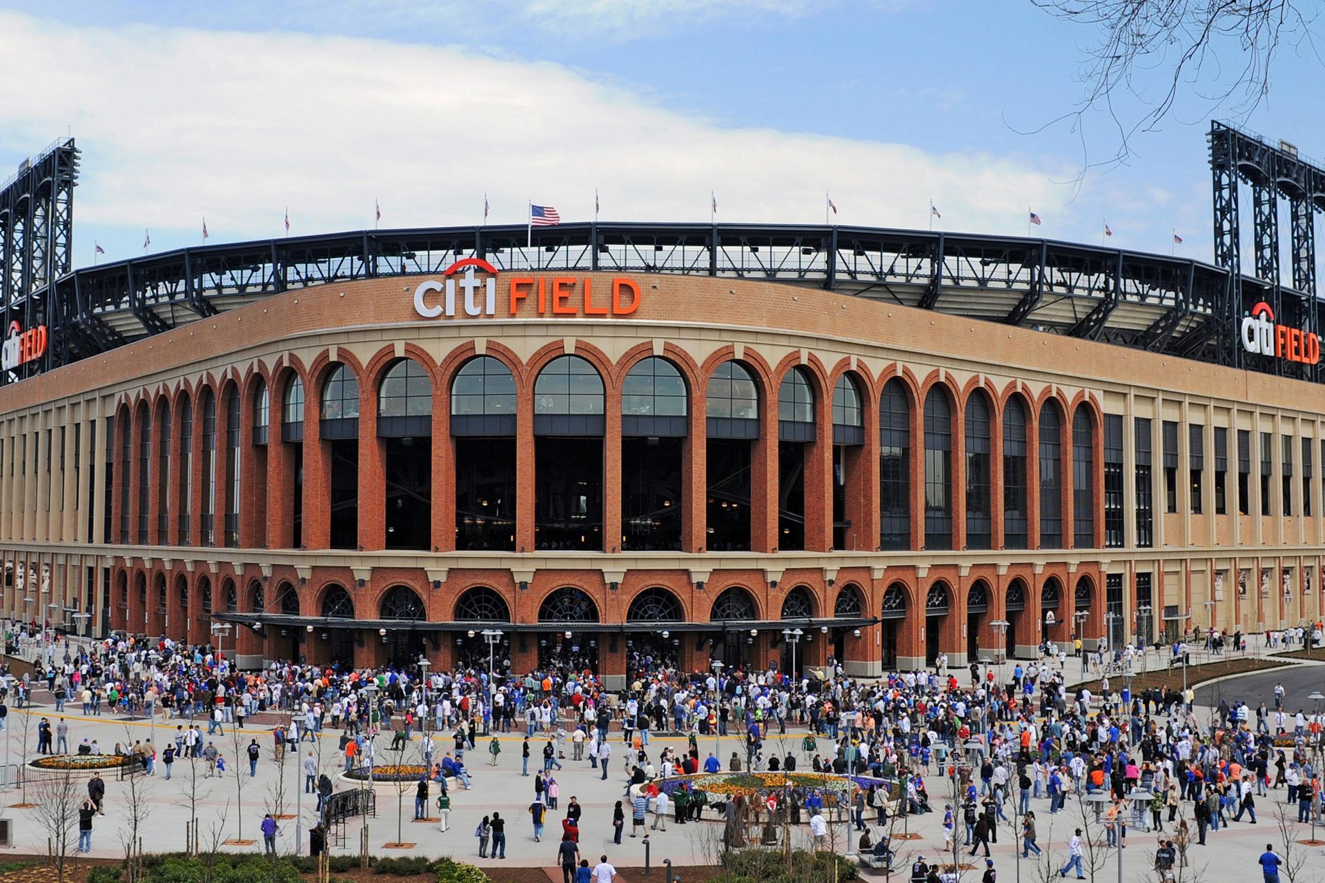 A large crowd of people are gathered outside citi field