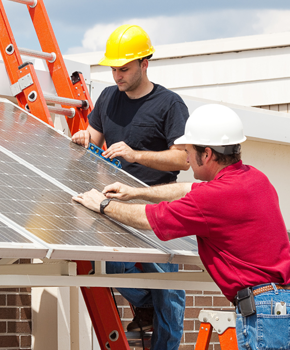 Men installing solar electric device