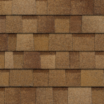A close-up of brown, textured asphalt roof shingles with a layered, rectangular pattern.