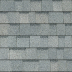 A close-up, top-down view of gray asphalt roofing shingles arranged in an overlapping horizontal pattern.
