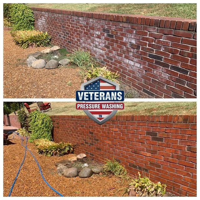 Before and after pressure washing of a brick wall, showing the difference in cleanliness.