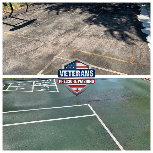 Before and after pressure washing: old asphalt with faded lines transformed to clean green play area with bright lines.