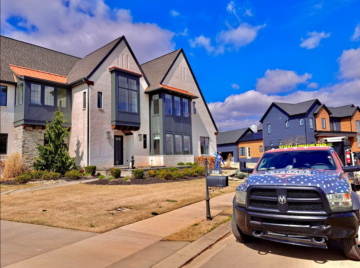 Townhouses on a sunny day with a patriotic truck parked on the street.