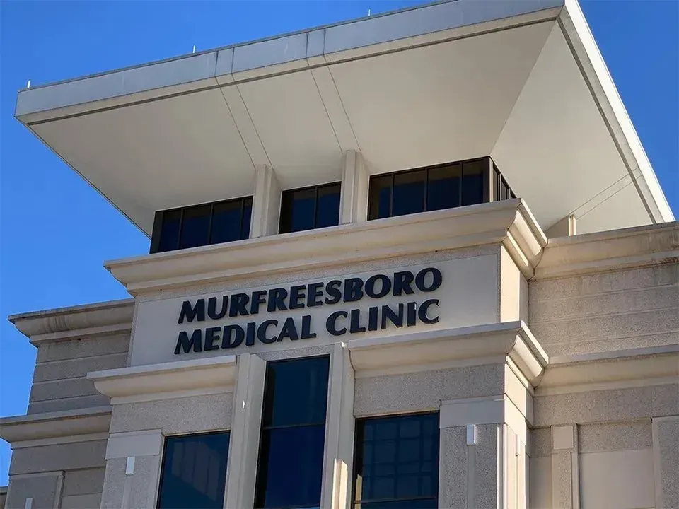 Murfreesboro Medical Clinic building with sign against a blue sky.