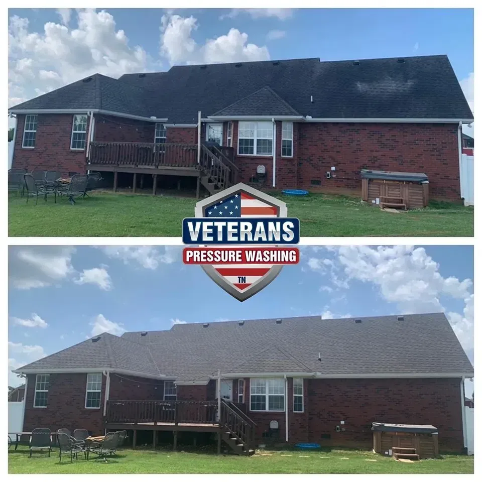 Before and after of a brick house roof cleaning. Dark, algae-covered roof becomes clean, gray after power washing.