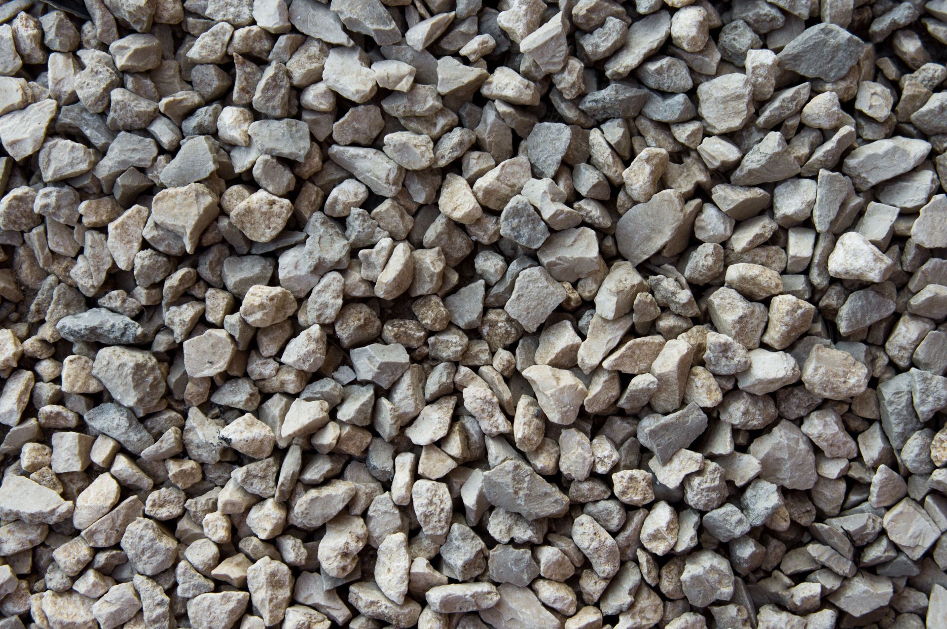 Gray and tan gravel aggregate, close-up view.