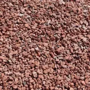 Red gravel, small and textured, fills the frame.