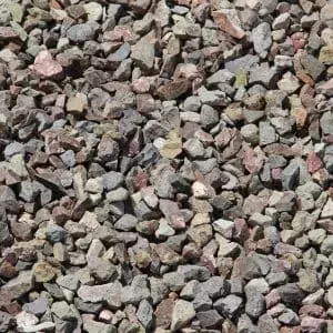 Gravel rock with mixed colors, including gray, brown, and pink.