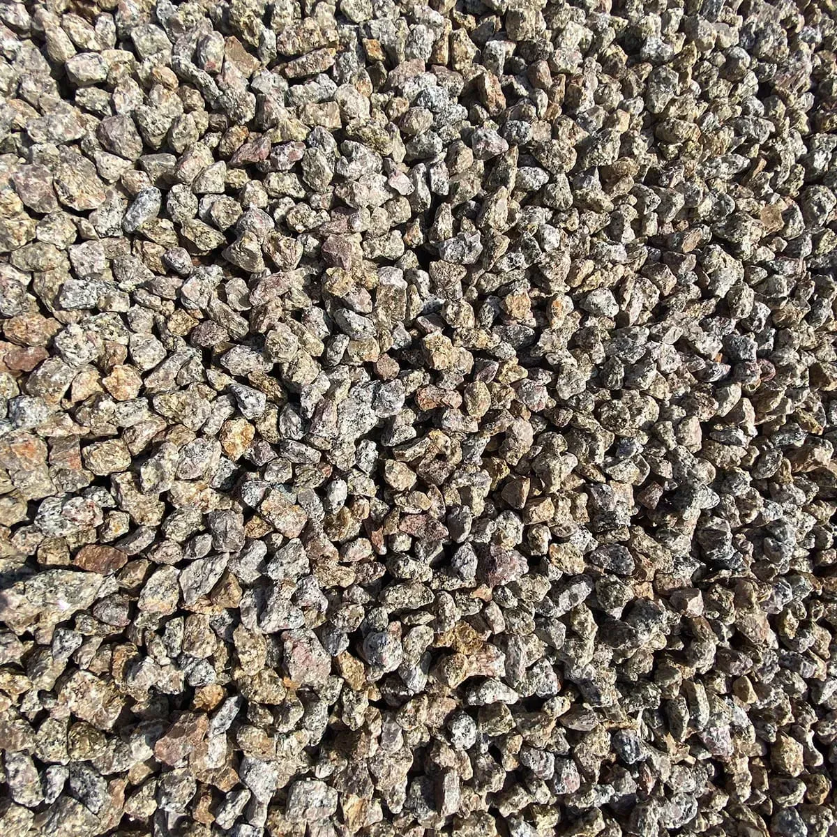 Close-up of a pile of small, light brown and tan gravel stones.