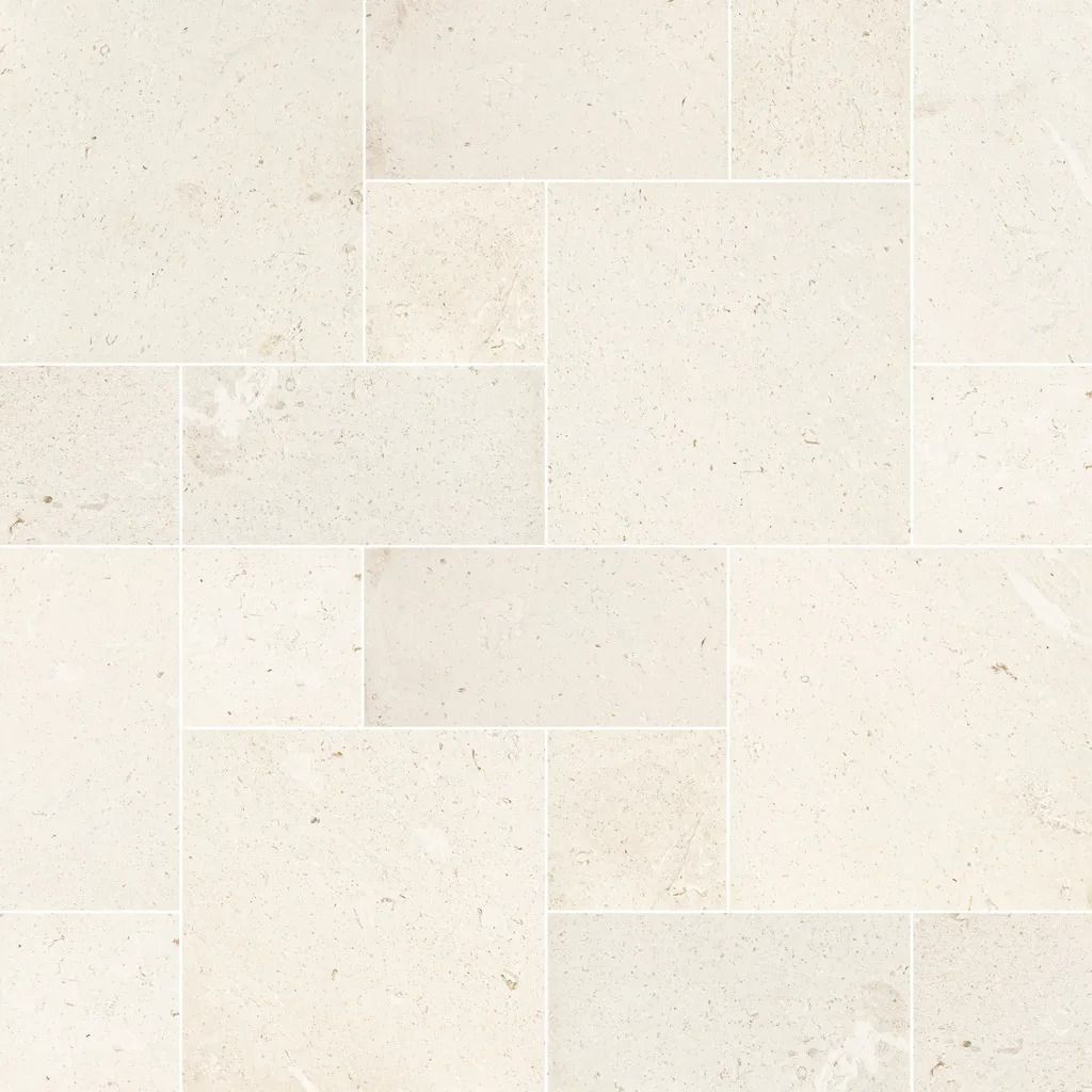 Cream-colored stone tile pattern, rectangular and square shapes, with white grout lines.