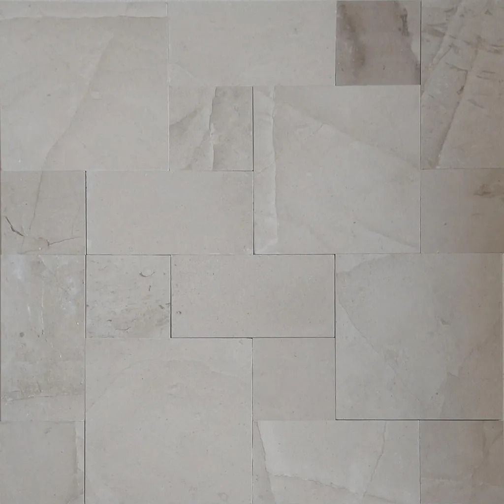 Beige marble tile wall with a random rectangular pattern.