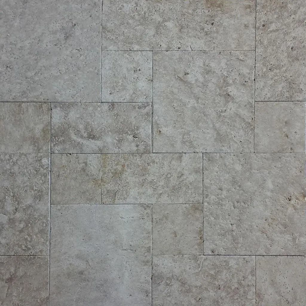 Stone tile in a neutral color, arranged in a rectangular pattern.