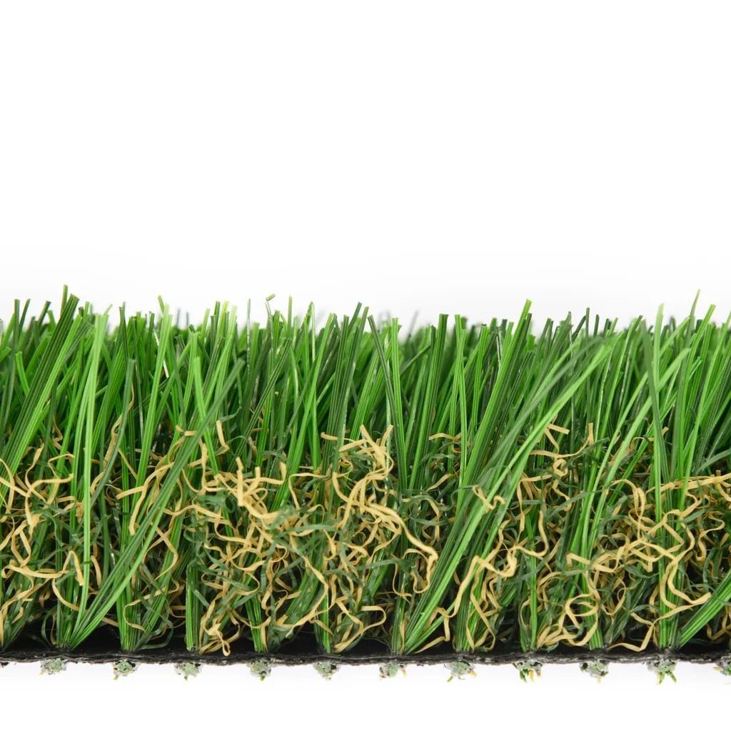 Close-up of artificial turf showing green blades with tan thatch over a black backing.