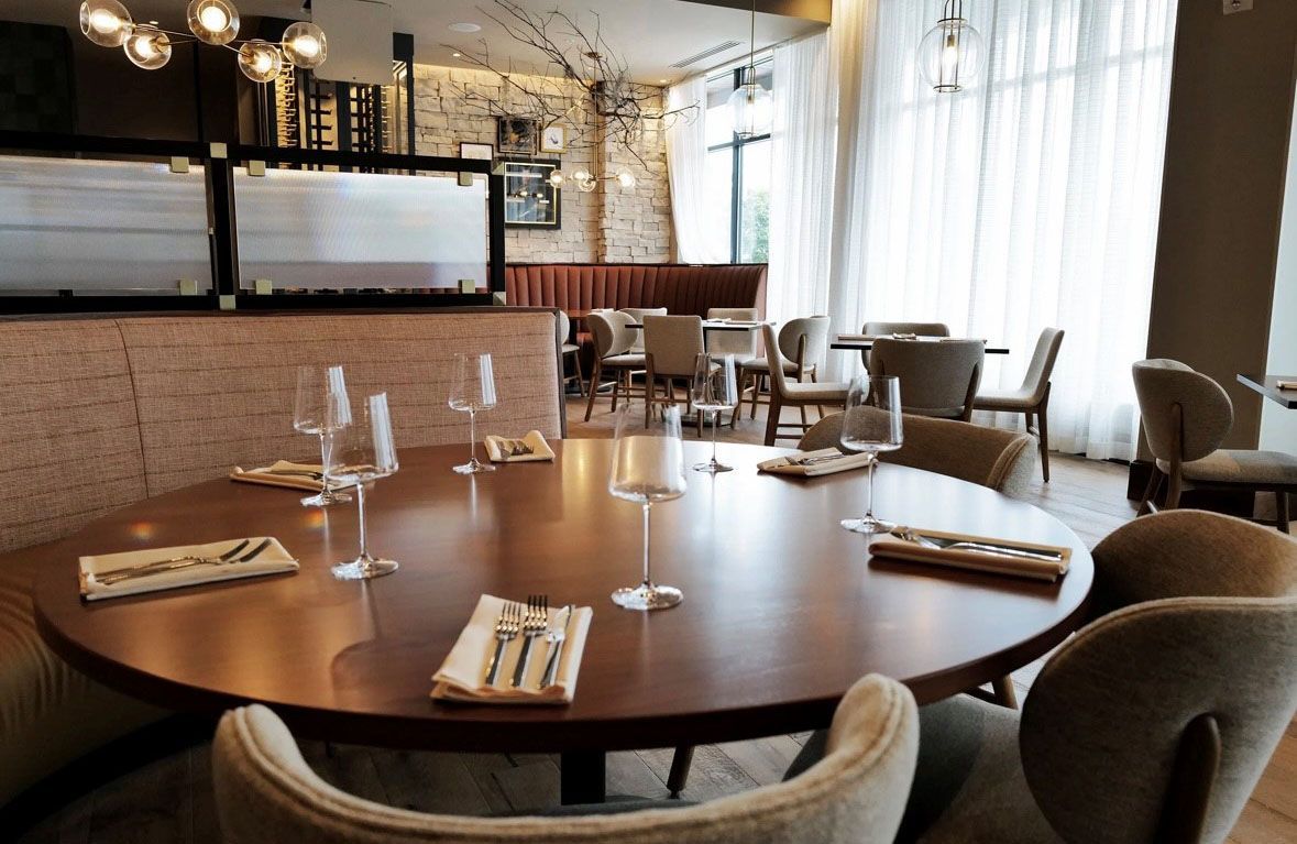 A round table and chairs set for a meal.