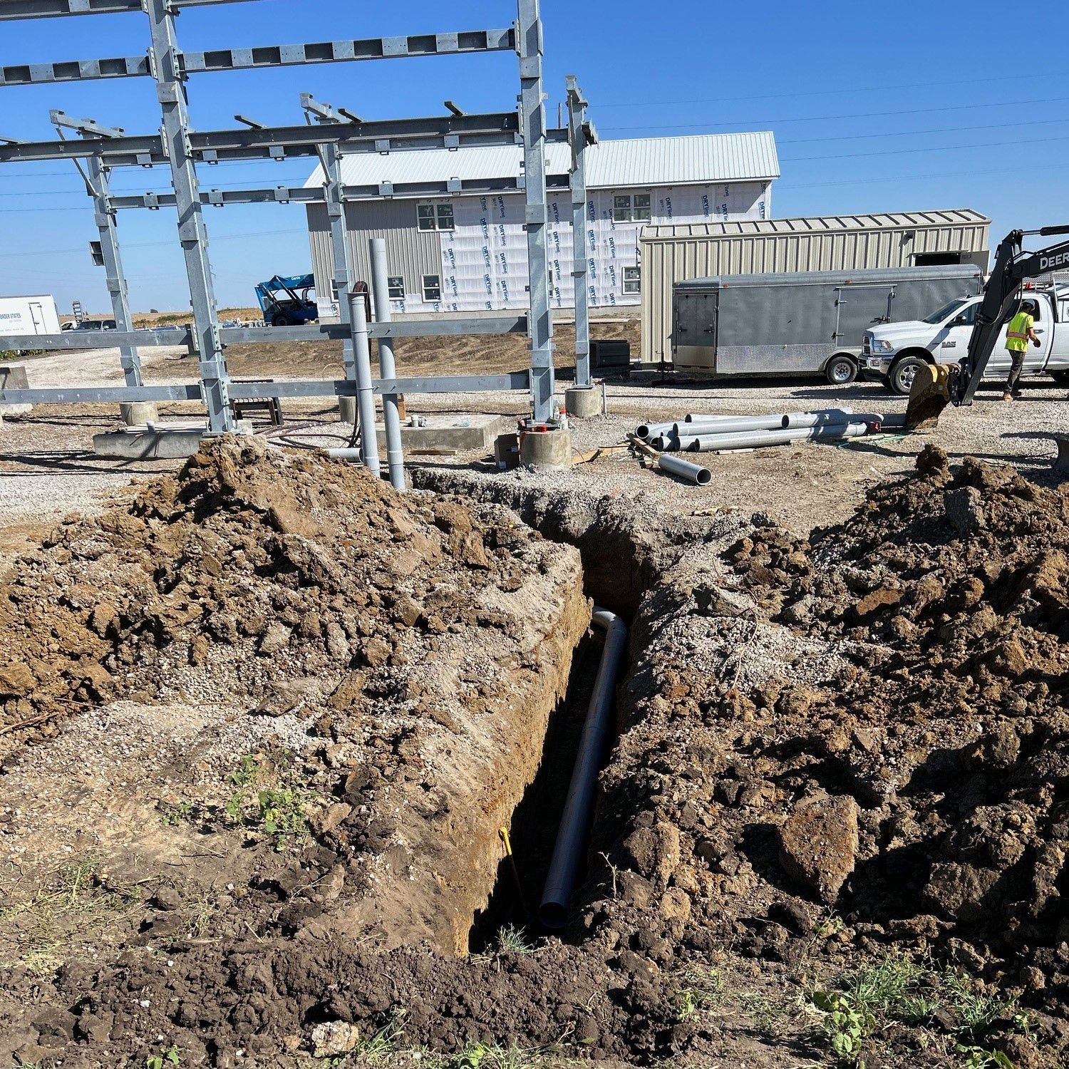 A large hole in the ground with a pipe in it