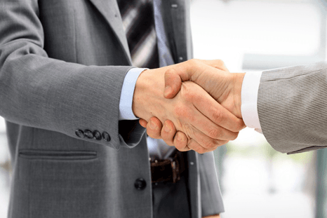 Insurance staff shaking hands with his client
