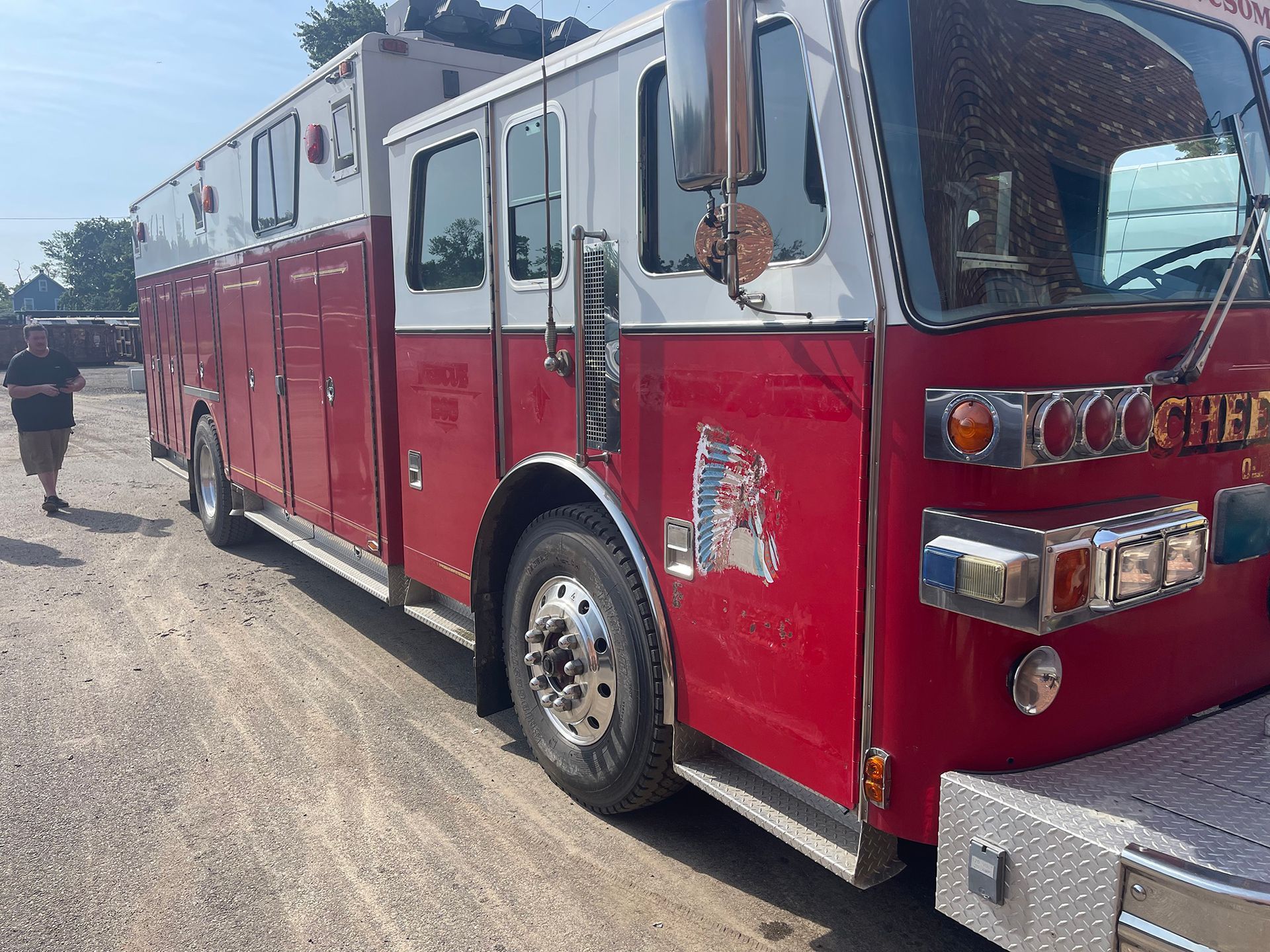 Red fire truck parked outdoors on a sunny street