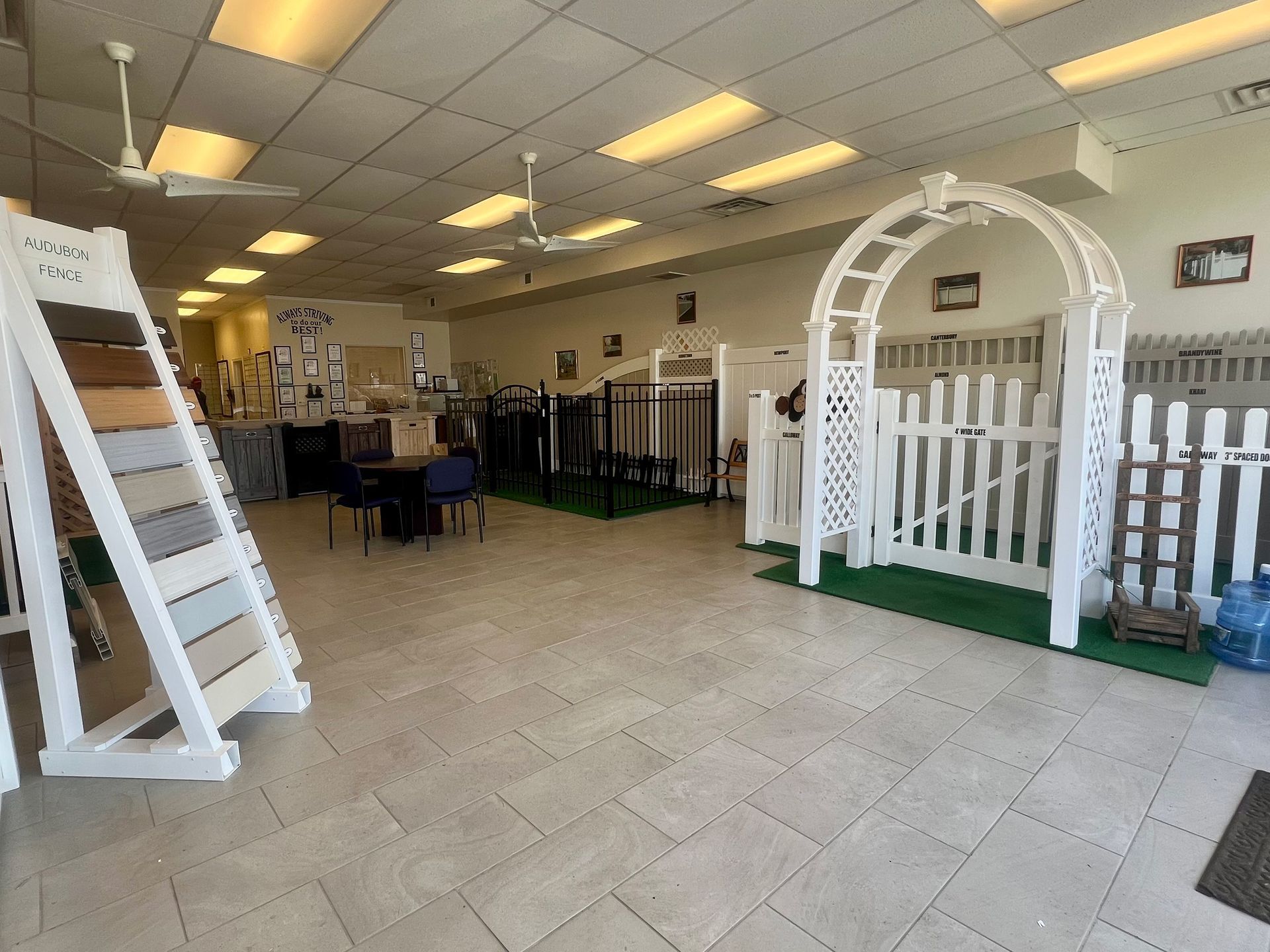 A large room with a white fence and a white arch in it.
