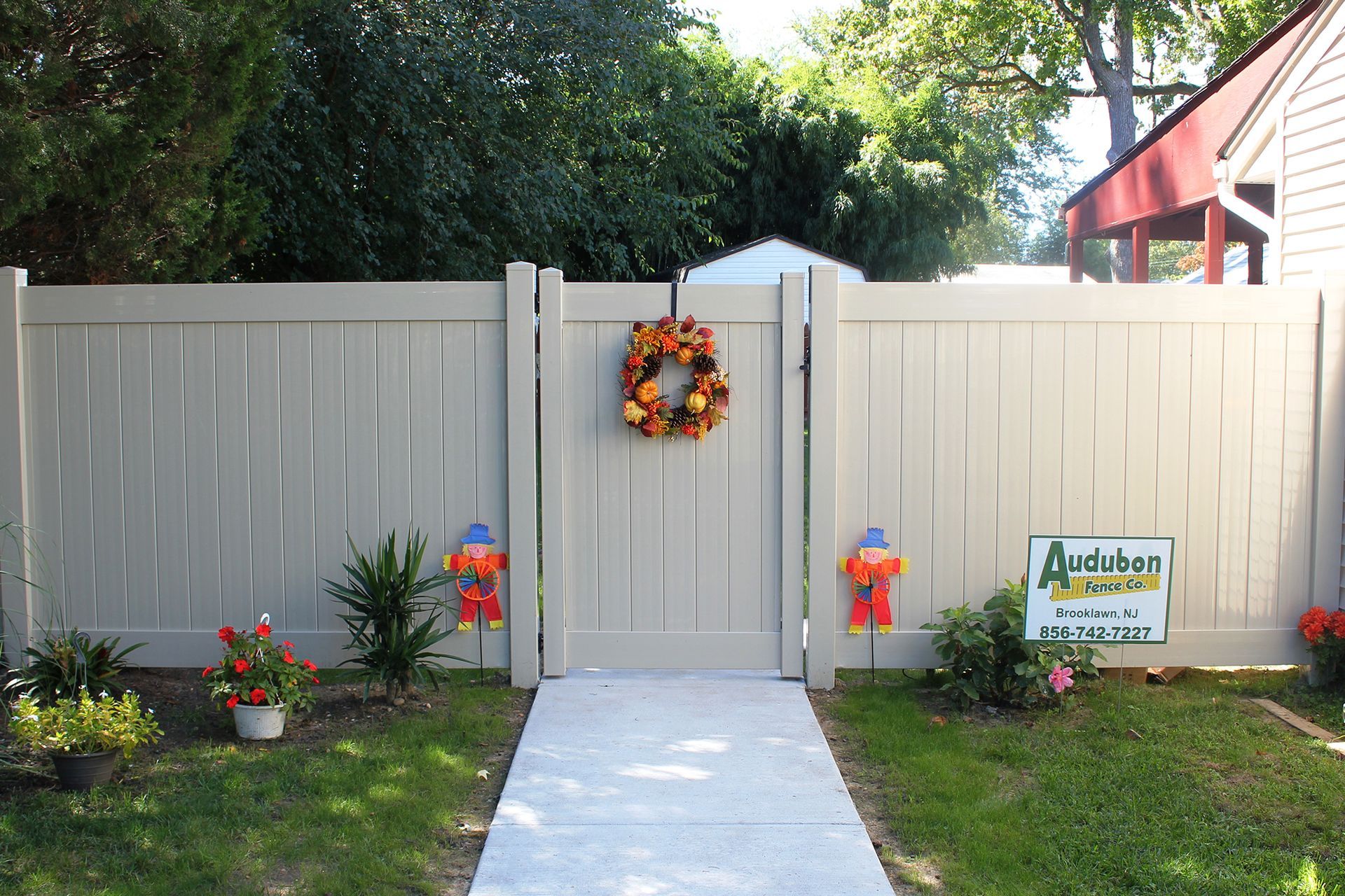 A white fence with a wreath hanging on it