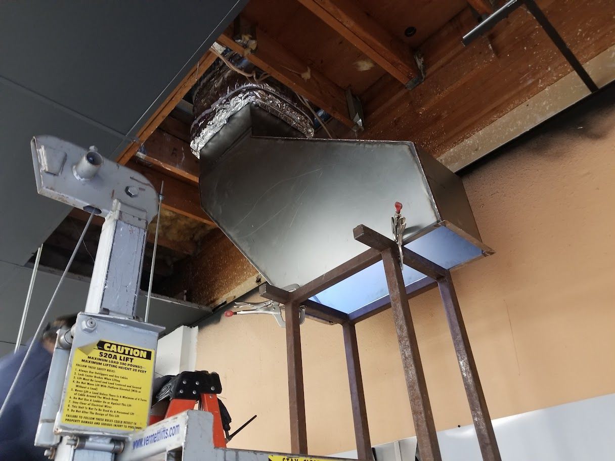 A machine with a yellow sign that says 'warning' on it.