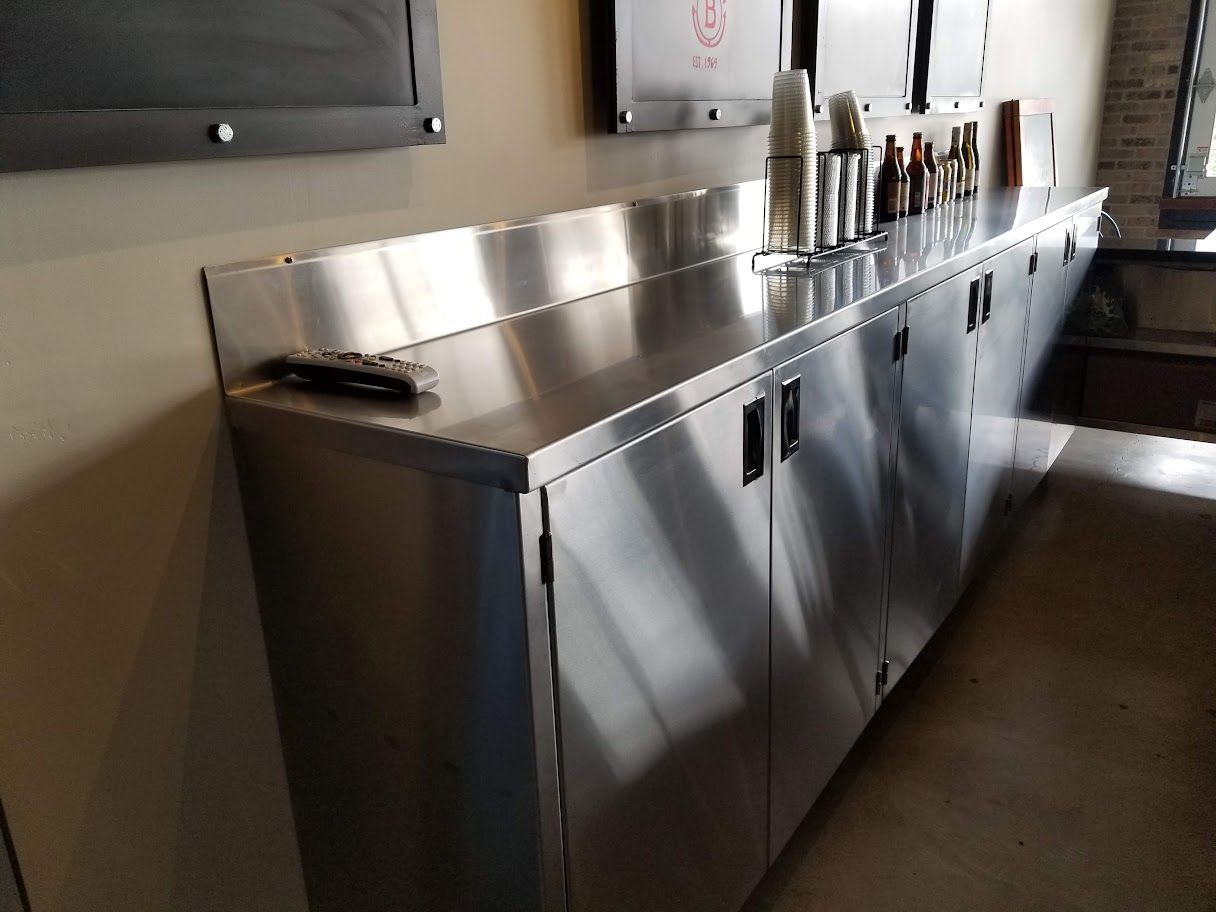 A kitchen with stainless steel cabinets and countertops.