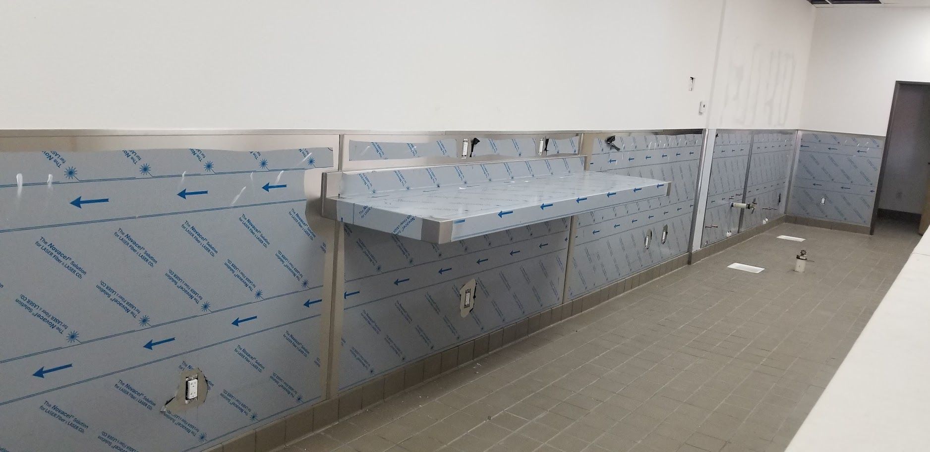 A stainless steel sink is being built in a kitchen.