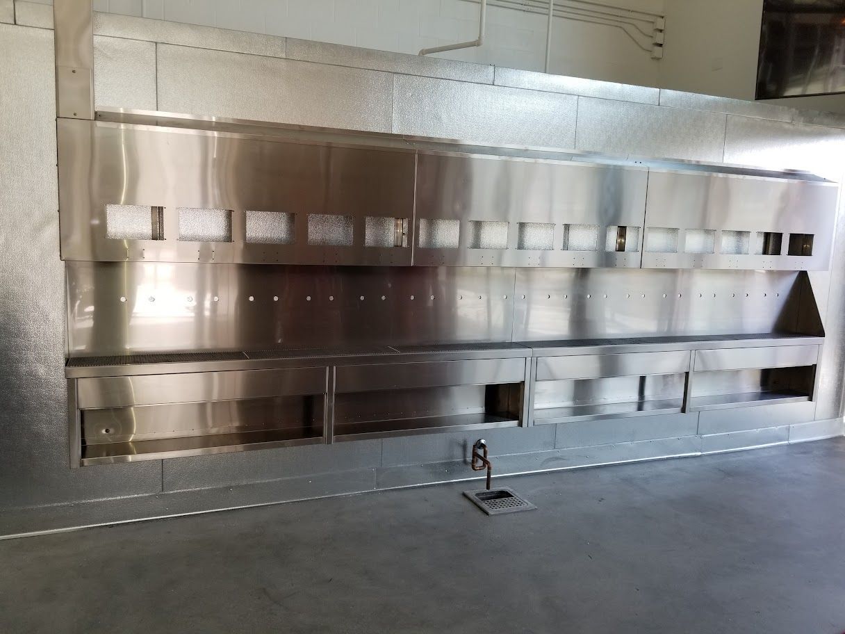 A kitchen with a lot of stainless steel appliances.