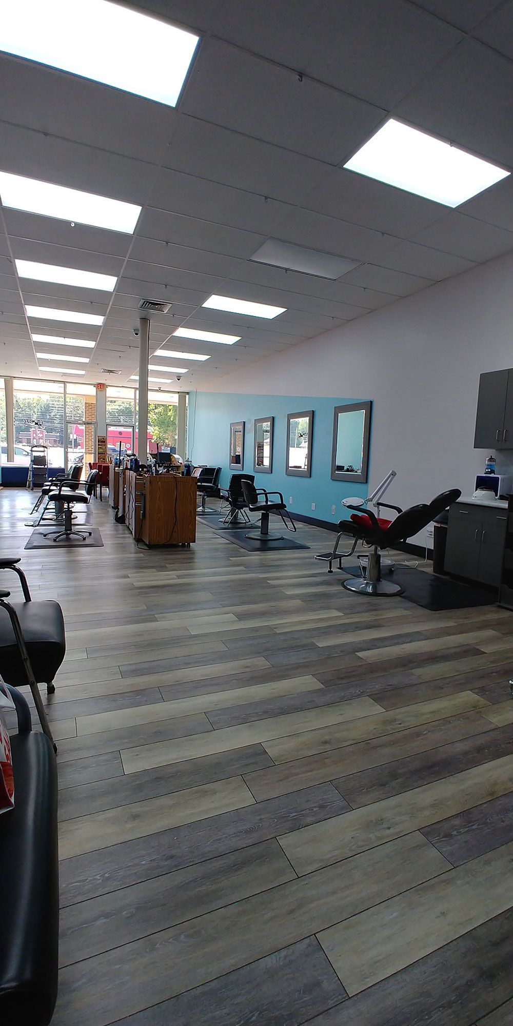 The inside of a hair salon with a lot of chairs and mirrors