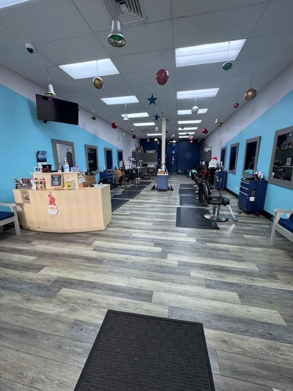 A salon with blue walls and wooden floors
