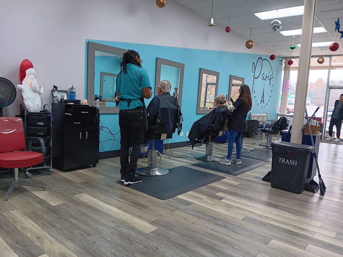 A woman is getting her hair cut at a hair salon