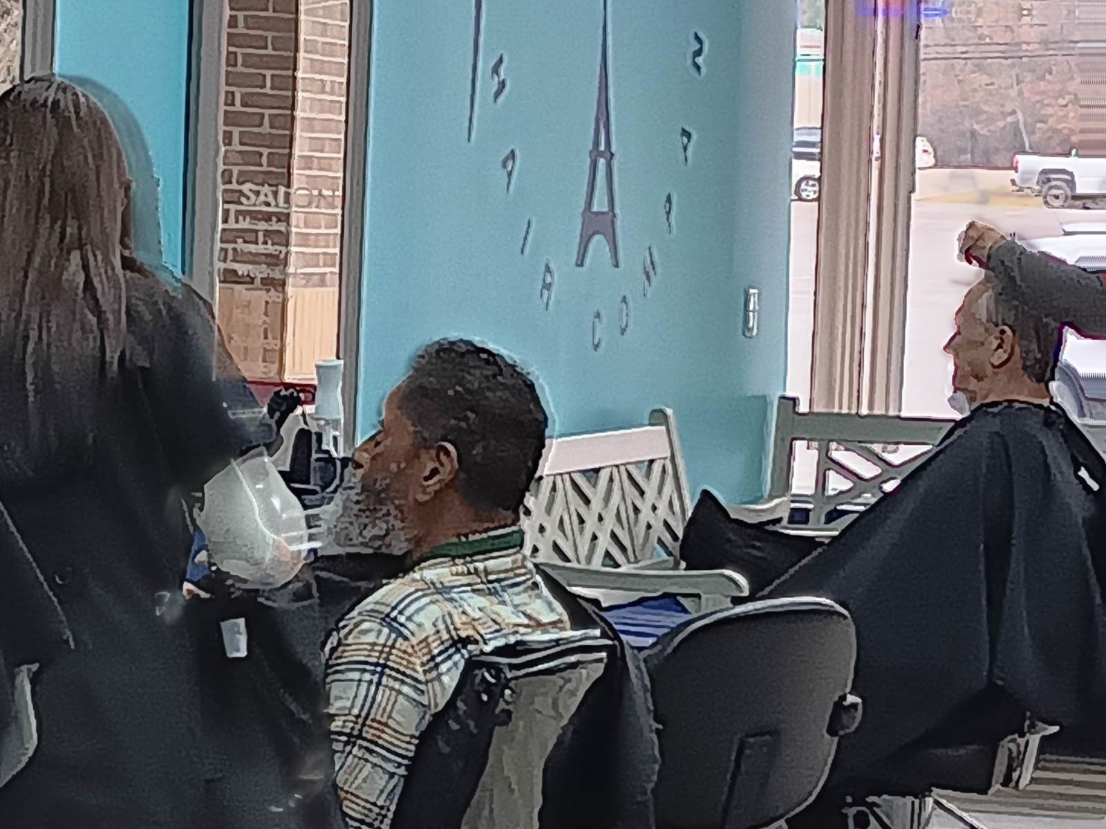 A man is getting his hair cut at the hair salon
