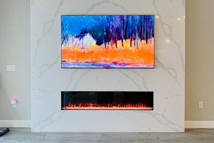 Outdoor patio with a brick fire pit and built-in bench seating with blue and white pillows.