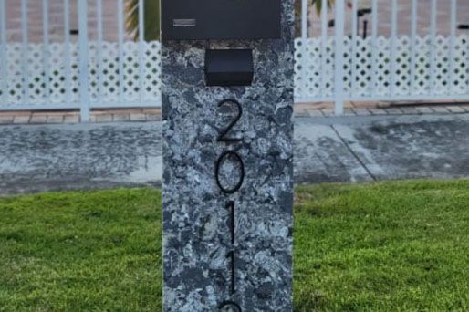 Luxurious bathroom with wood cabinets, stone tile, and built-in bathtub on a platform.