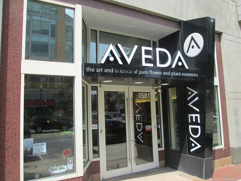Aveda salon entrance with black and white signage and glass doors.